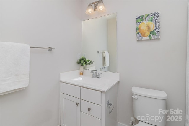 bathroom featuring toilet and vanity