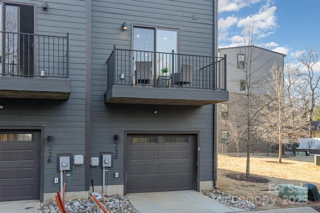 exterior space featuring an attached garage and a balcony