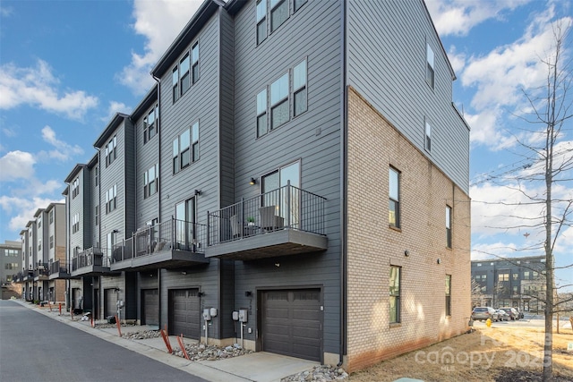 view of property with a garage and a residential view