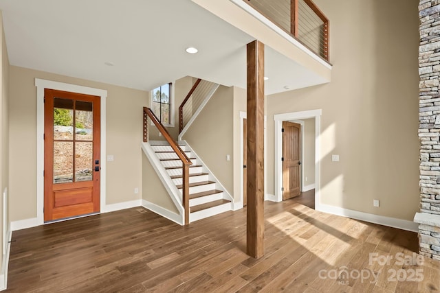 entrance foyer featuring stairs, recessed lighting, baseboards, and wood finished floors