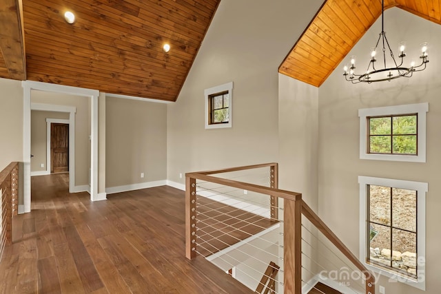 hall with wood ceiling, high vaulted ceiling, dark wood finished floors, and an upstairs landing