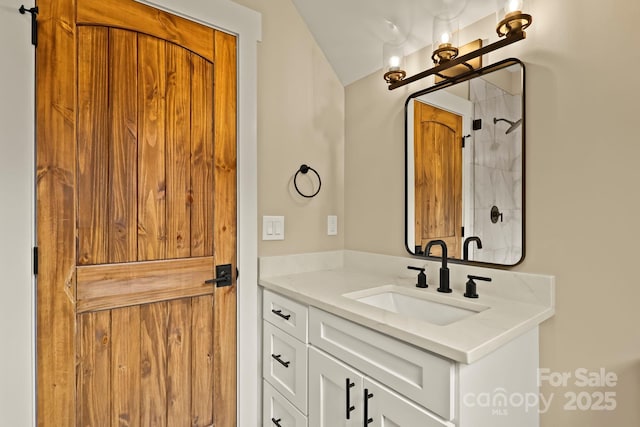 bathroom featuring walk in shower and vanity