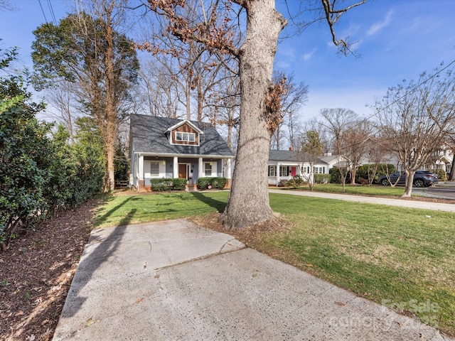 cape cod-style house with covered porch and a front lawn