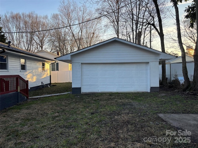 view of garage at dusk