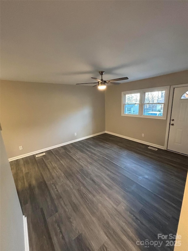 interior space with dark wood-type flooring and ceiling fan