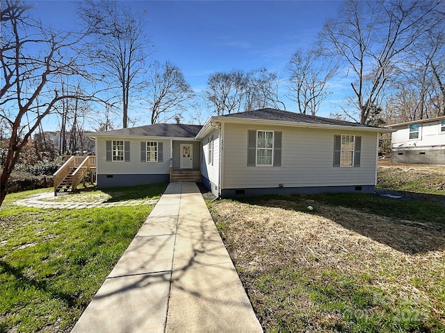 view of front of home featuring entry steps, a front lawn, crawl space, and stairway