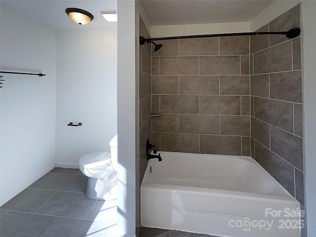 full bathroom featuring baseboards, toilet, tile patterned floors, tub / shower combination, and a textured ceiling