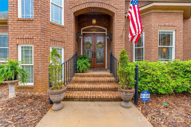 entrance to property featuring brick siding