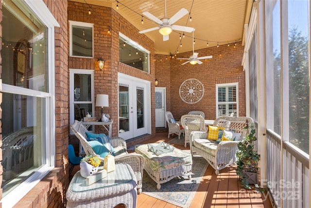 sunroom featuring track lighting and french doors