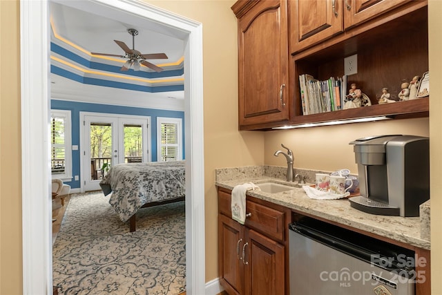 bar with a tray ceiling, french doors, crown molding, ceiling fan, and dishwashing machine