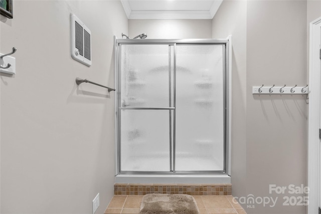 full bathroom featuring visible vents, crown molding, a shower stall, and tile patterned floors