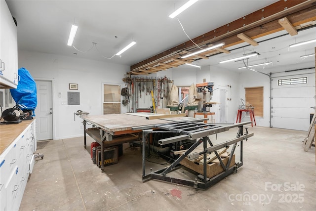 garage featuring a workshop area and electric panel