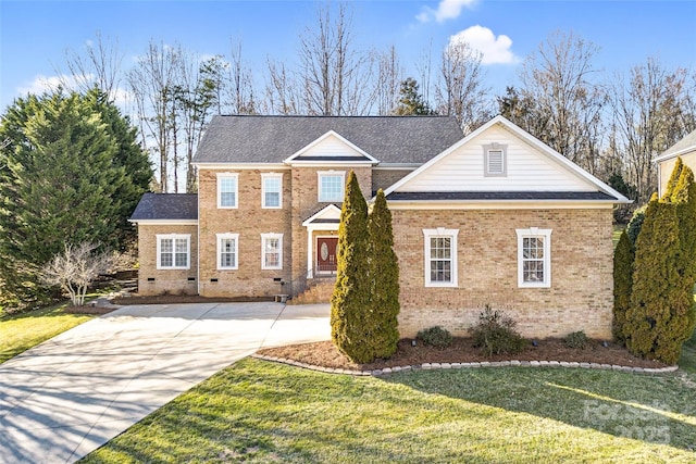 view of front of home with a shingled roof, crawl space, brick siding, and a front lawn