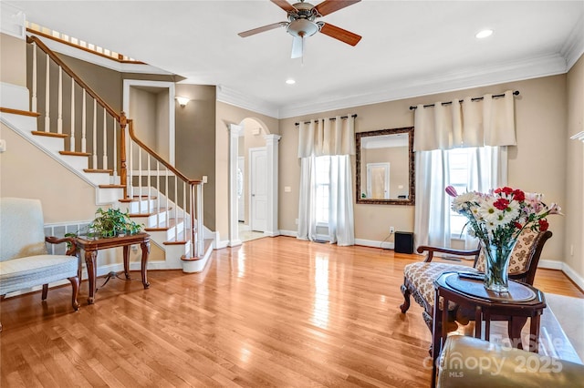 entrance foyer with baseboards, stairway, ornamental molding, wood finished floors, and ornate columns