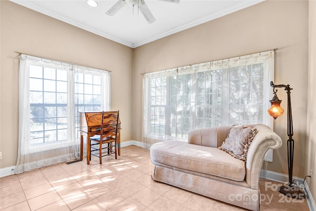 sitting room featuring baseboards, ornamental molding, and ceiling fan