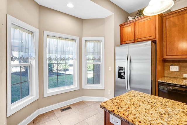 kitchen with stainless steel fridge, decorative backsplash, dishwasher, light stone countertops, and light tile patterned flooring