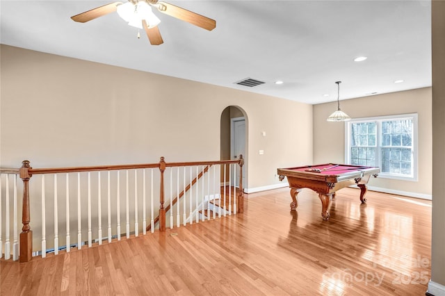 rec room featuring arched walkways, recessed lighting, visible vents, baseboards, and light wood-type flooring