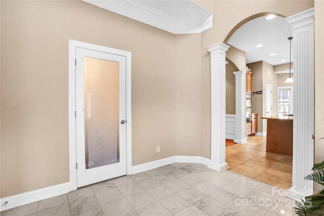 empty room with arched walkways, baseboards, marble finish floor, ornamental molding, and decorative columns