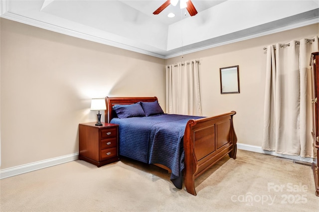 bedroom with light carpet, crown molding, a raised ceiling, and baseboards