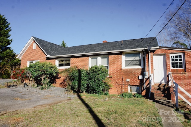 rear view of house featuring a lawn