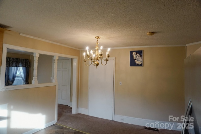 unfurnished dining area featuring carpet floors, ornamental molding, a chandelier, and a textured ceiling