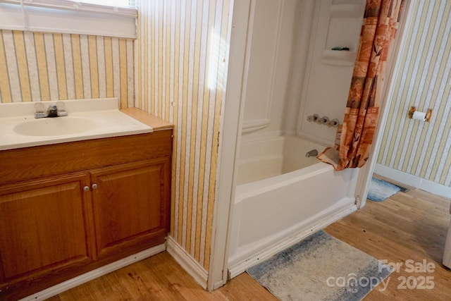 bathroom featuring hardwood / wood-style floors, shower / tub combo with curtain, and vanity