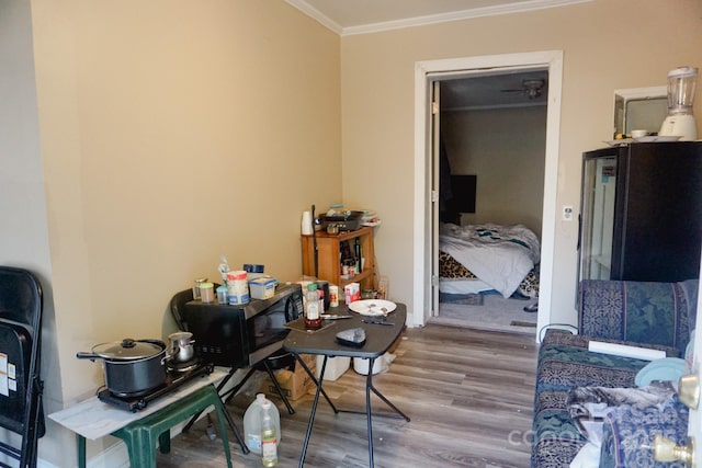 interior space with hardwood / wood-style flooring and crown molding