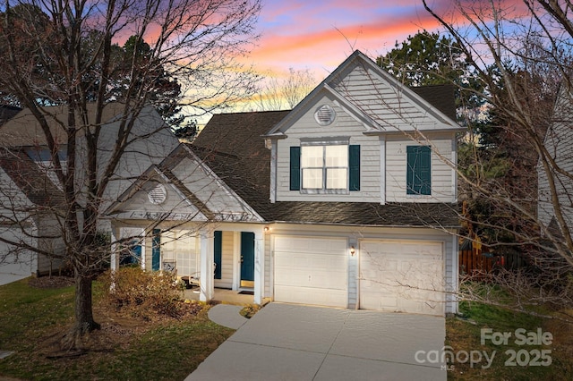 traditional home with a garage and driveway