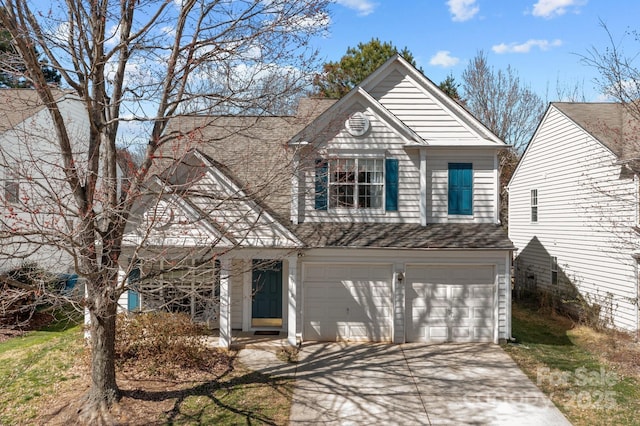 traditional home with a garage, concrete driveway, and roof with shingles