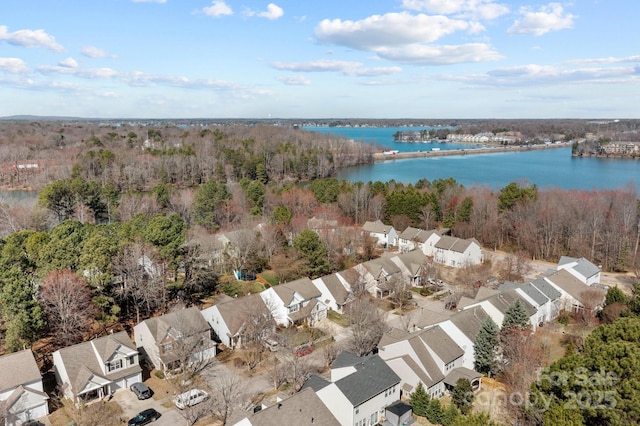 birds eye view of property featuring a water view, a residential view, and a view of trees