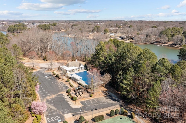 aerial view with a water view and a forest view