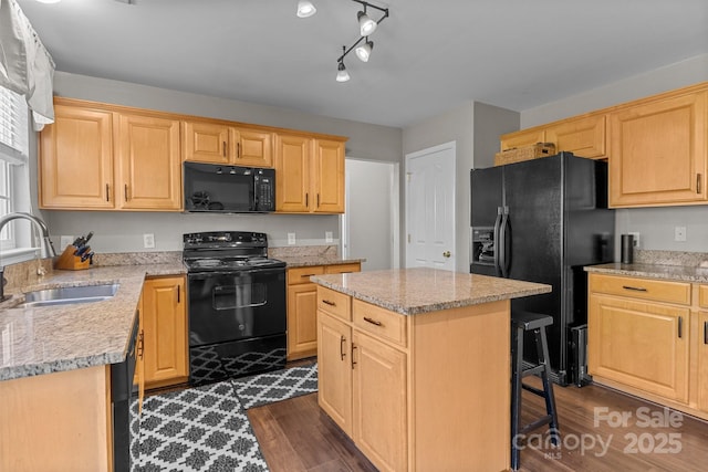 kitchen featuring dark wood-type flooring, light brown cabinets, a sink, and black appliances