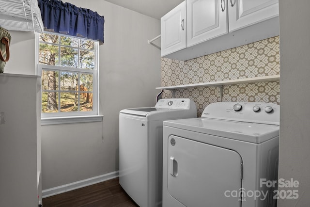 laundry area with dark wood-style flooring, cabinet space, independent washer and dryer, baseboards, and wallpapered walls