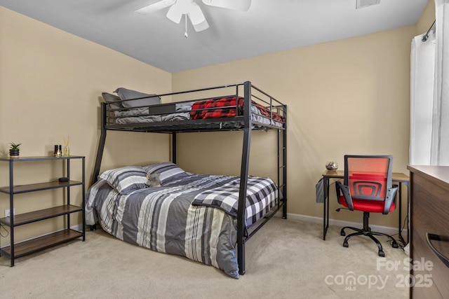 carpeted bedroom featuring ceiling fan, visible vents, and baseboards