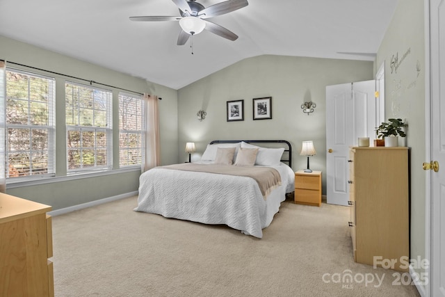 bedroom with lofted ceiling, ceiling fan, baseboards, and light colored carpet