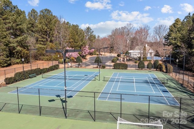 view of sport court featuring fence