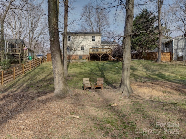 view of yard with stairway, a fenced backyard, and a deck