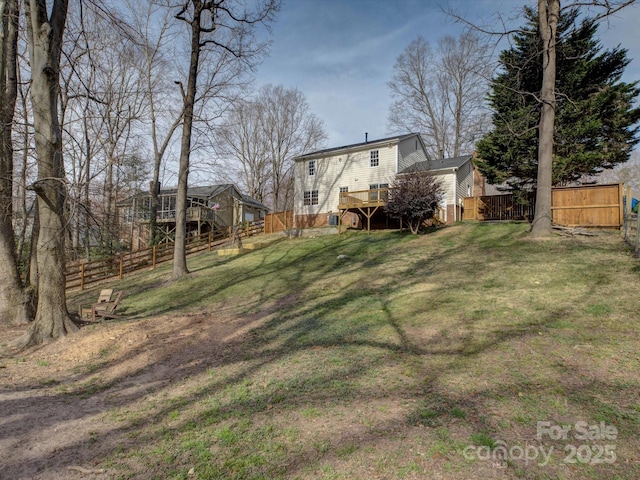 view of yard with a deck, stairway, and a fenced backyard