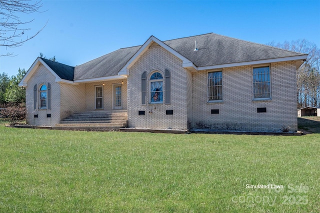 view of front facade with crawl space, brick siding, a front lawn, and roof with shingles