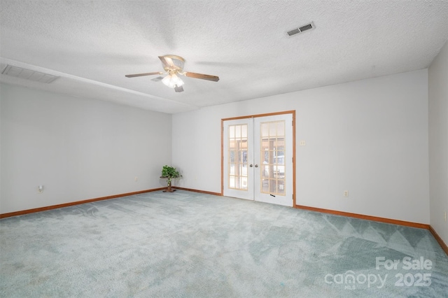 spare room with french doors, visible vents, baseboards, and carpet flooring