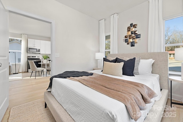 bedroom featuring light wood-type flooring and multiple windows