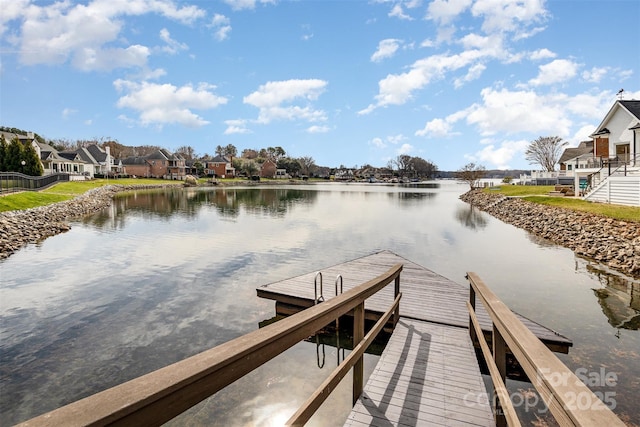 view of dock with a water view and a residential view