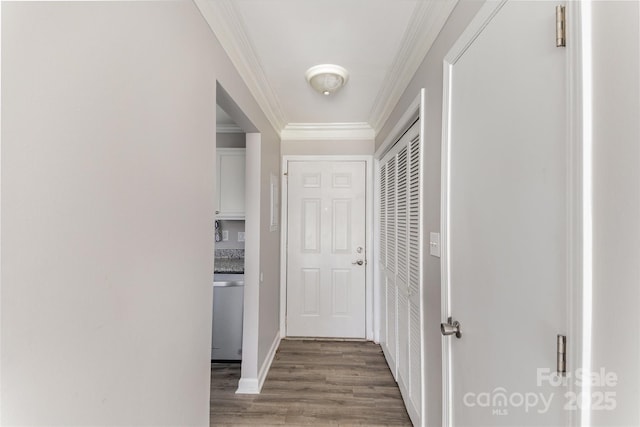 hall featuring ornamental molding and wood finished floors