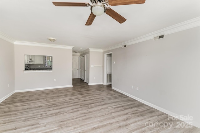 unfurnished room with light wood-type flooring, visible vents, and ornamental molding