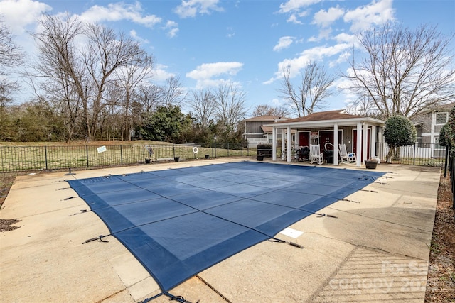 community pool with a patio area, a storage structure, an outdoor structure, and fence