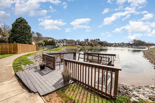 view of dock with fence and a deck with water view