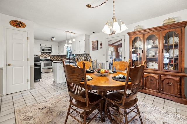 dining space featuring a chandelier and light tile patterned flooring
