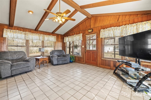tiled living room featuring wood walls, lofted ceiling with beams, and ceiling fan