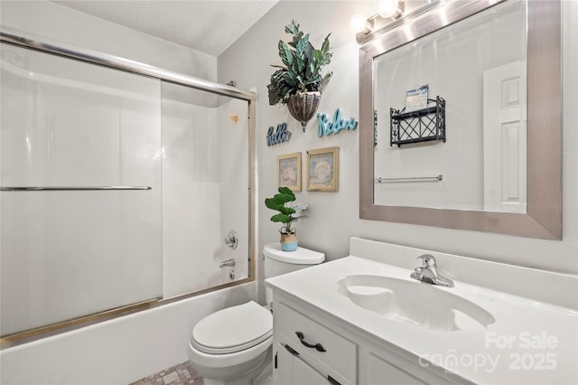 full bathroom with enclosed tub / shower combo, a textured ceiling, vanity, and toilet
