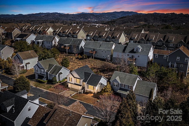 drone / aerial view featuring a residential view and a mountain view